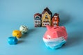 Piggy bank with medical mask, small piggy banks and house models
