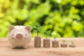 Piggybank And a pile of coins with the tops of trees That represents saving.