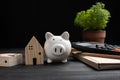 Piggybank and Small wooden houses with modern design and calculator for home loans concept Royalty Free Stock Photo