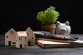 Piggybank and Small wooden houses with modern design and calculator for home loans concept Royalty Free Stock Photo