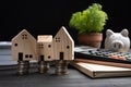 Piggybank and Small wooden houses with modern design and calculator for home loans concept Royalty Free Stock Photo