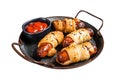 Pigs in Blanket puff pastry sausage wrap roll. Isolated, white background.