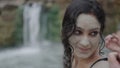 Pigtailed girl smiles as she looks back at her friend in a lake