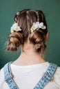 Pigtails little girl flowers backside green background Royalty Free Stock Photo