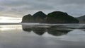 Piha black sand beach featuring cliffs and rock formations at Waitakere in New Zealand