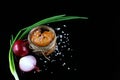 Pike caviar, roe in a glass jar, purple and green onion, sea salt on a black background, close-up, place for text, set