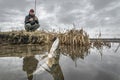 Pike fishing. Hooked muskie fish on fisherman background