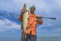 Pike fishing. Successful fisherman hold muskie fish