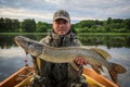 Pike fishing in summer Scandinavian lake Royalty Free Stock Photo