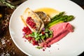 Pike-perch fillet. Asparagus, pearl couscous, white wine sauce, beet-flavored mashed potatoes. Delicious seafood fish