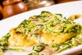 Pike-perch fillet baked with cheese, mushrooms and spinach