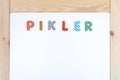 Pikler pedagogy text made from toy letters on an scadinavian style table