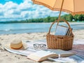 Piknik basket, book and glasses on blanket under umbrella on beach sand