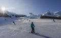 Skiers at ski resort in Pila, Valle d`Aosta, Italy with chairlift and mountain backdrop and copy space - winter sports concept Royalty Free Stock Photo