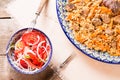 Pilaf and achichuk salad in handmade plate on wooden background