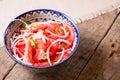 Pilaf and achichuk salad in handmade plate on wooden background