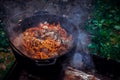 Pilaf in the cauldron on the fire