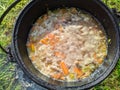 pilaf in a cauldron on an open fire in the daytime in summer. Royalty Free Stock Photo