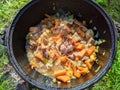 pilaf in a cauldron on an open fire in the daytime in summer. Royalty Free Stock Photo