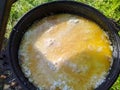 pilaf in a cauldron on an open fire in the daytime in summer. Royalty Free Stock Photo