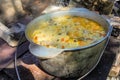 Pilaf is cooked in a cast-iron pot on a fire Royalty Free Stock Photo