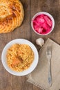 Pilaf in a plate, Asian bread, salted cabbage on the table