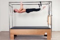 Pilates aerobic instructor man in cadillac fitness