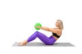 Pilates with mini ball. Attractive fit woman practice roll down exercise with a small green rubber fitball in hands Royalty Free Stock Photo