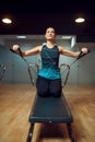 Pilates training on exercise machine in gym