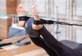 Pilates training for legs woman using fitness ball while exercising on pilates reformer Royalty Free Stock Photo