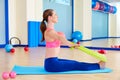 Pilates woman rowing rubber band exercise