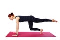 Pilates or yoga. This slender beautiful woman performs a Pilates exercise on a gym mat. Isolated on a white background