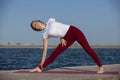 Pilates yoga workout exercise outdoor in the lake pier