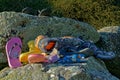 A pile of abandoned or lost shoes and assorted footwear