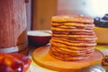 Pile of air pancakes on a wooden dinette, a traditional food family. pancakes of golden color Royalty Free Stock Photo