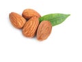 A pile of almonds seed and half with leaves isolated.