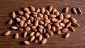 A pile of almonds on a wooden table Royalty Free Stock Photo