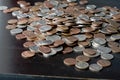 A pile of American cents on an old black wooden surface close-up. Money background Royalty Free Stock Photo