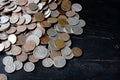 A pile of American cents on an old black wooden surface close-up. Money background Royalty Free Stock Photo