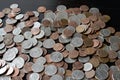 A pile of American cents on an old black wooden surface close-up. Money background Royalty Free Stock Photo