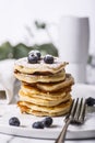 Pile of american pancakes with blueberries and powdered sugar. Royalty Free Stock Photo