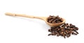 Pile of aromatic dry cloves and wooden spoon on white background Royalty Free Stock Photo