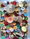 A pile of assorted colorful shirt buttons