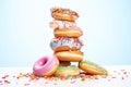 pile of assorted doughnuts with colorful icing and sprinkles Royalty Free Stock Photo