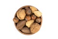 Pile of assorted nuts in the shell in a wood bowl isolated over white Royalty Free Stock Photo