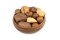 Pile of assorted nuts in the shell in a wood bowl isolated over white Royalty Free Stock Photo