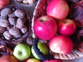 A pile of autumn fruit top view. Green red apples and walnuts in wicker baskets. Rustic style photo. Royalty Free Stock Photo