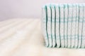 Pile with baby comfort and soft baby diapers on a white background, copy space, lightness