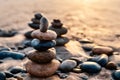 Pile of Balanced Rocks at the Beach at Golden Sunset in California Royalty Free Stock Photo