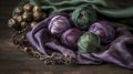 a pile of balls of yarn sitting on top of a purple cloth